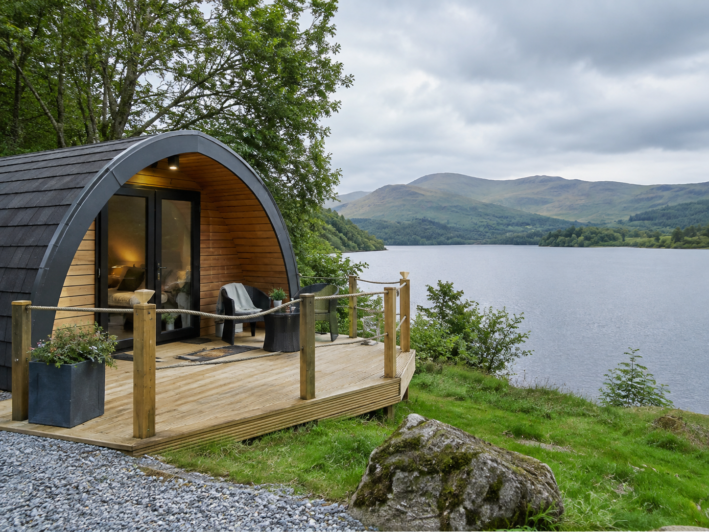 A lakeside glamping pod overlooking the UK countryside